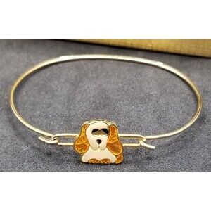 Donley gold-tone bangle bracelet featuring an enameled Cocker Spaniel charm